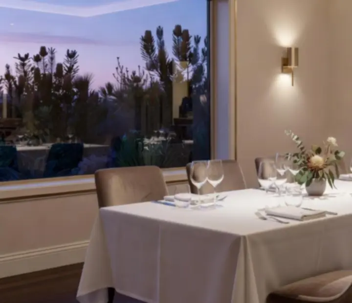 Elegant private dining room with candlelit tables at The River House