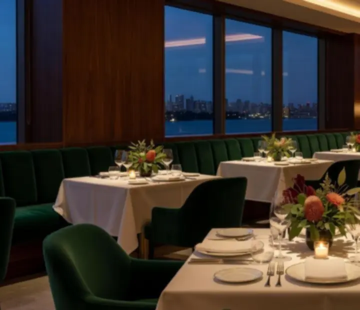 Cinematic twilight view of The River House dining room prepared for evening service.